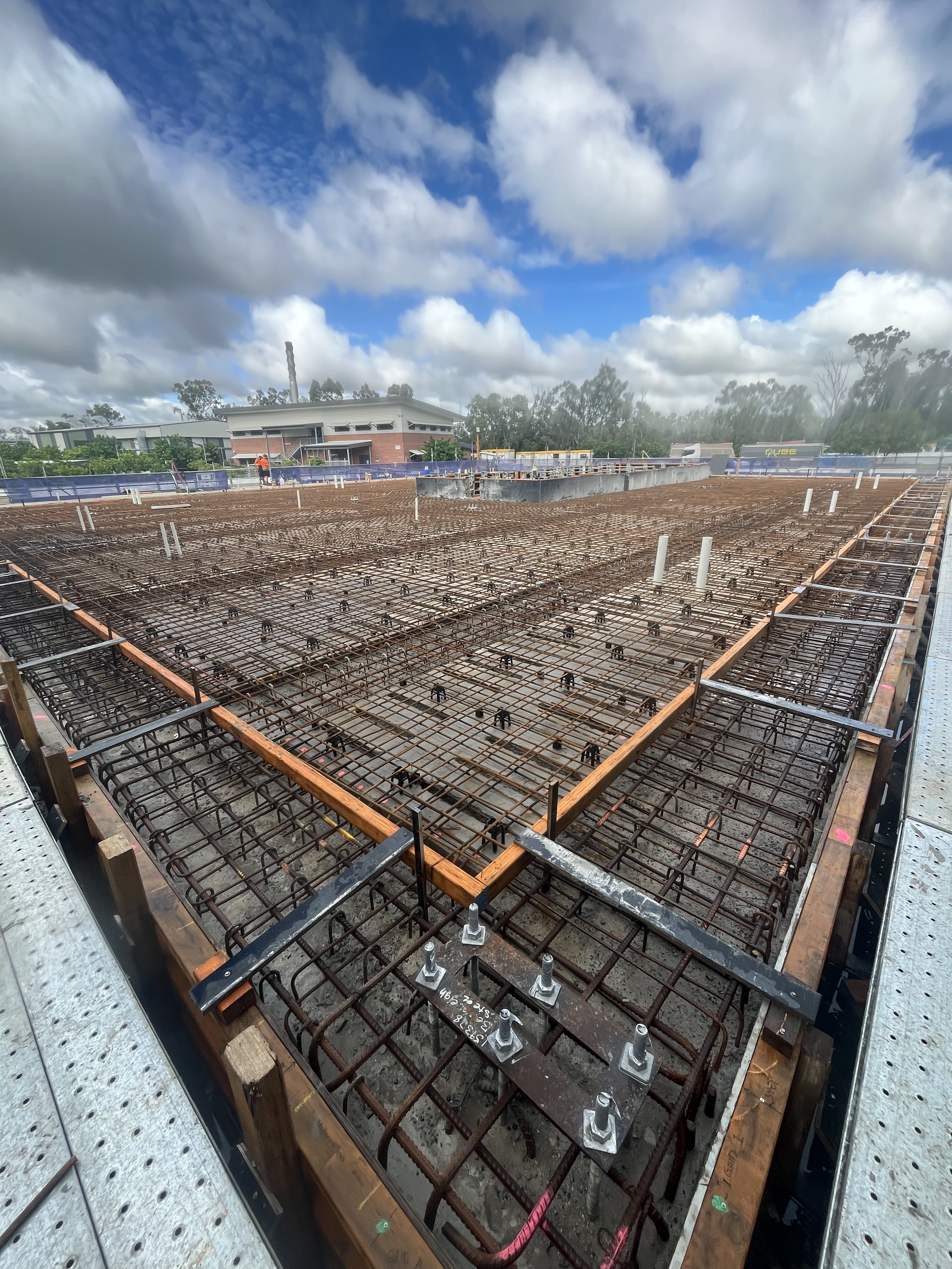 Large commercial concrete slab pre-pour with rebar mesh grid laid out in Rockhampton