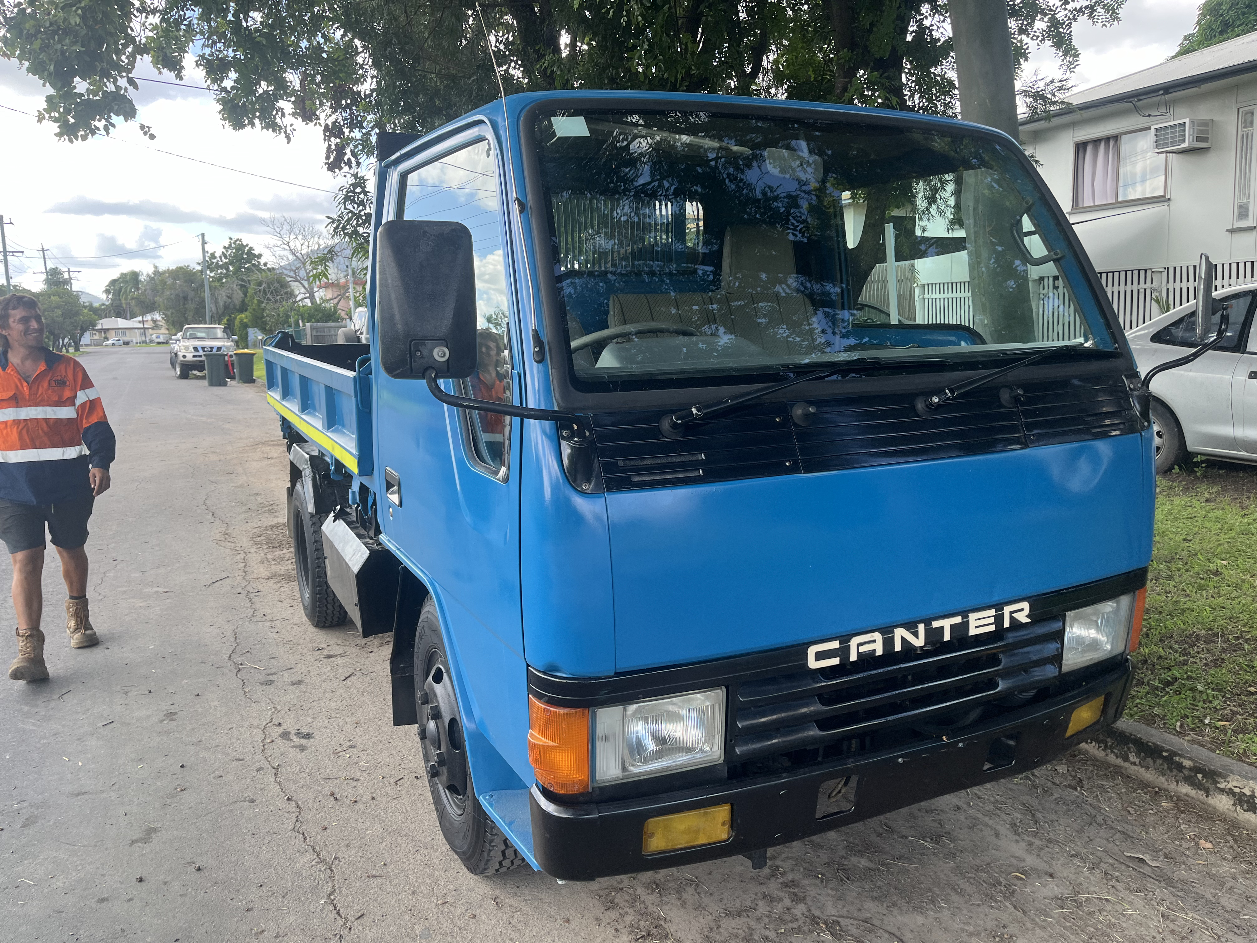 MSB Civil blue Mitsubishi Canter tipper truck parked on a suburban street