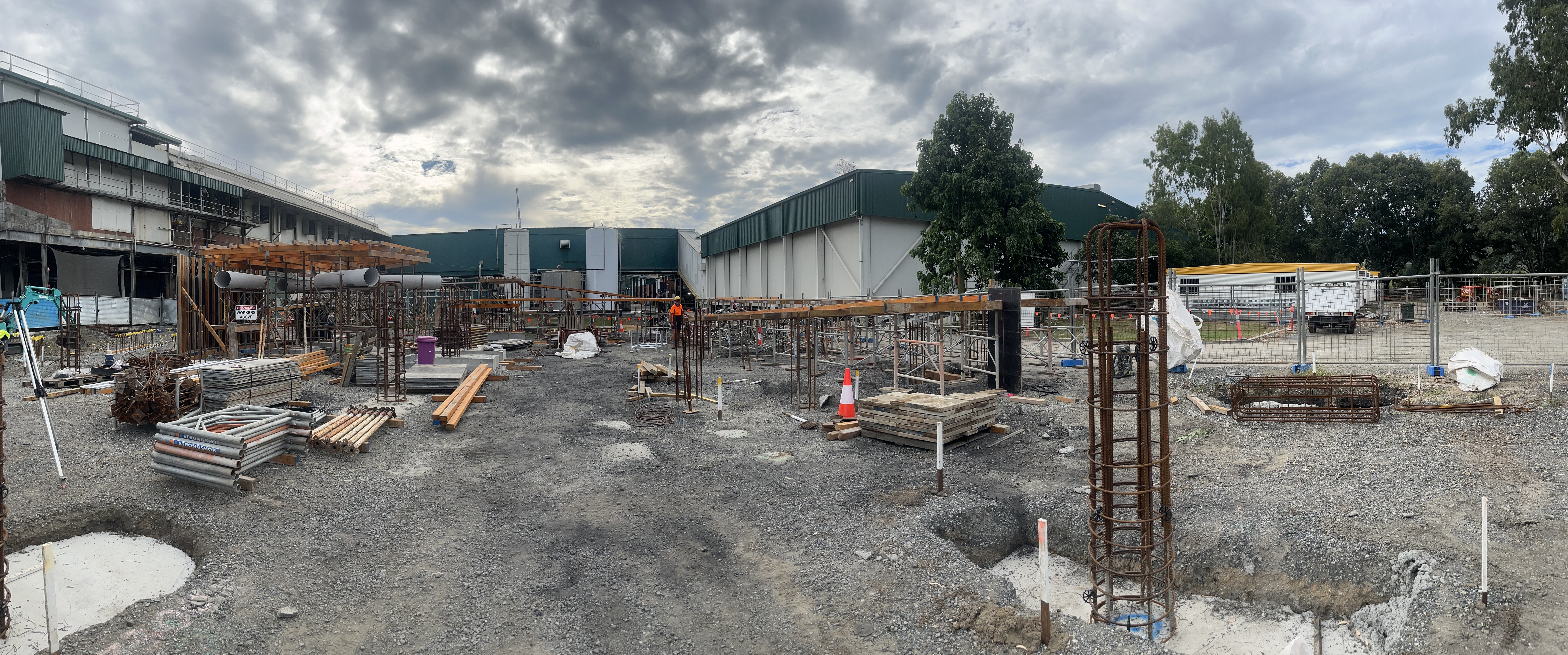 Wide panoramic view of commercial construction site — reo columns and early stage earthworks
