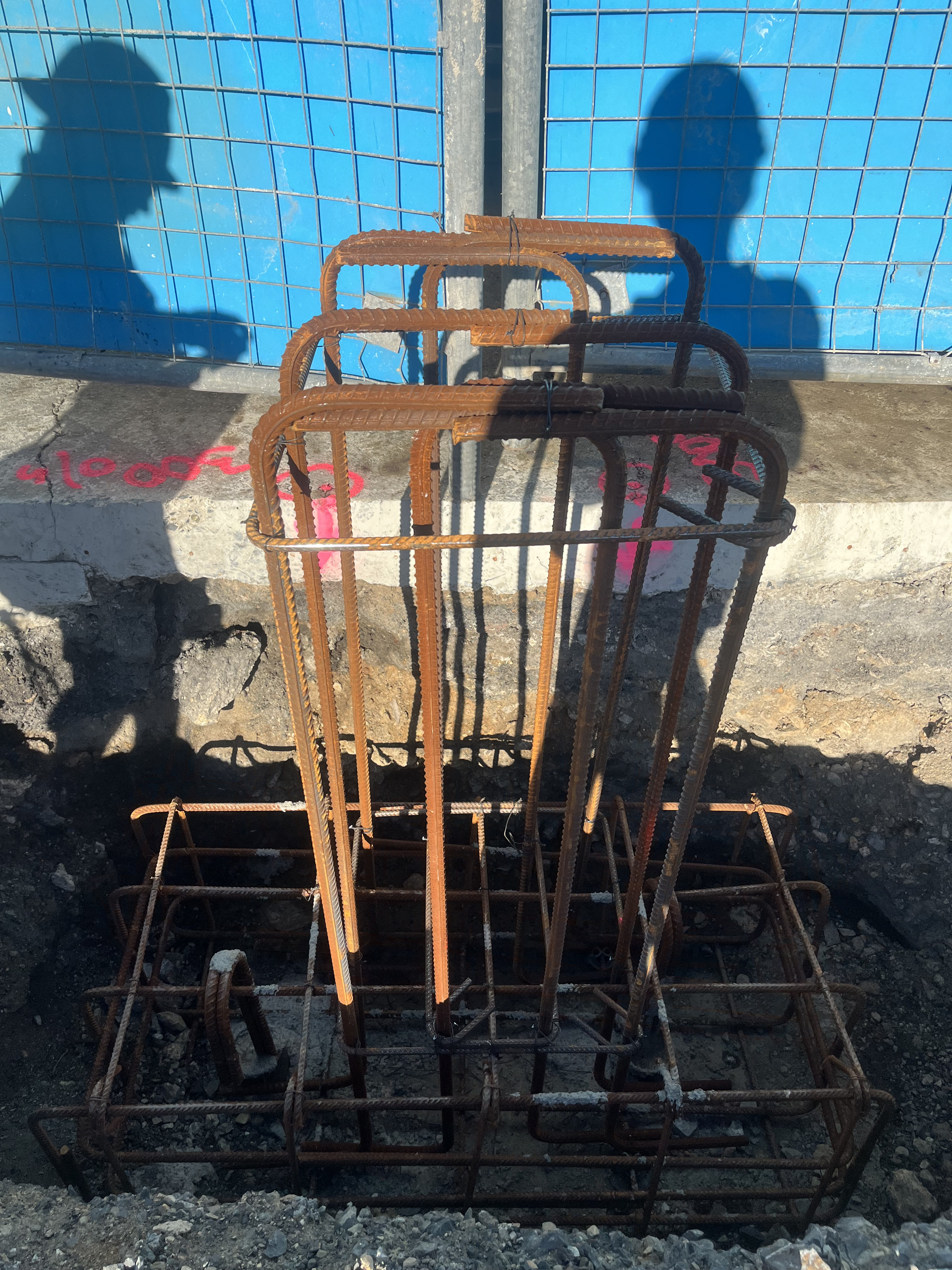 Column footing reinforcement cage sitting in excavated hole ready for concrete pour
