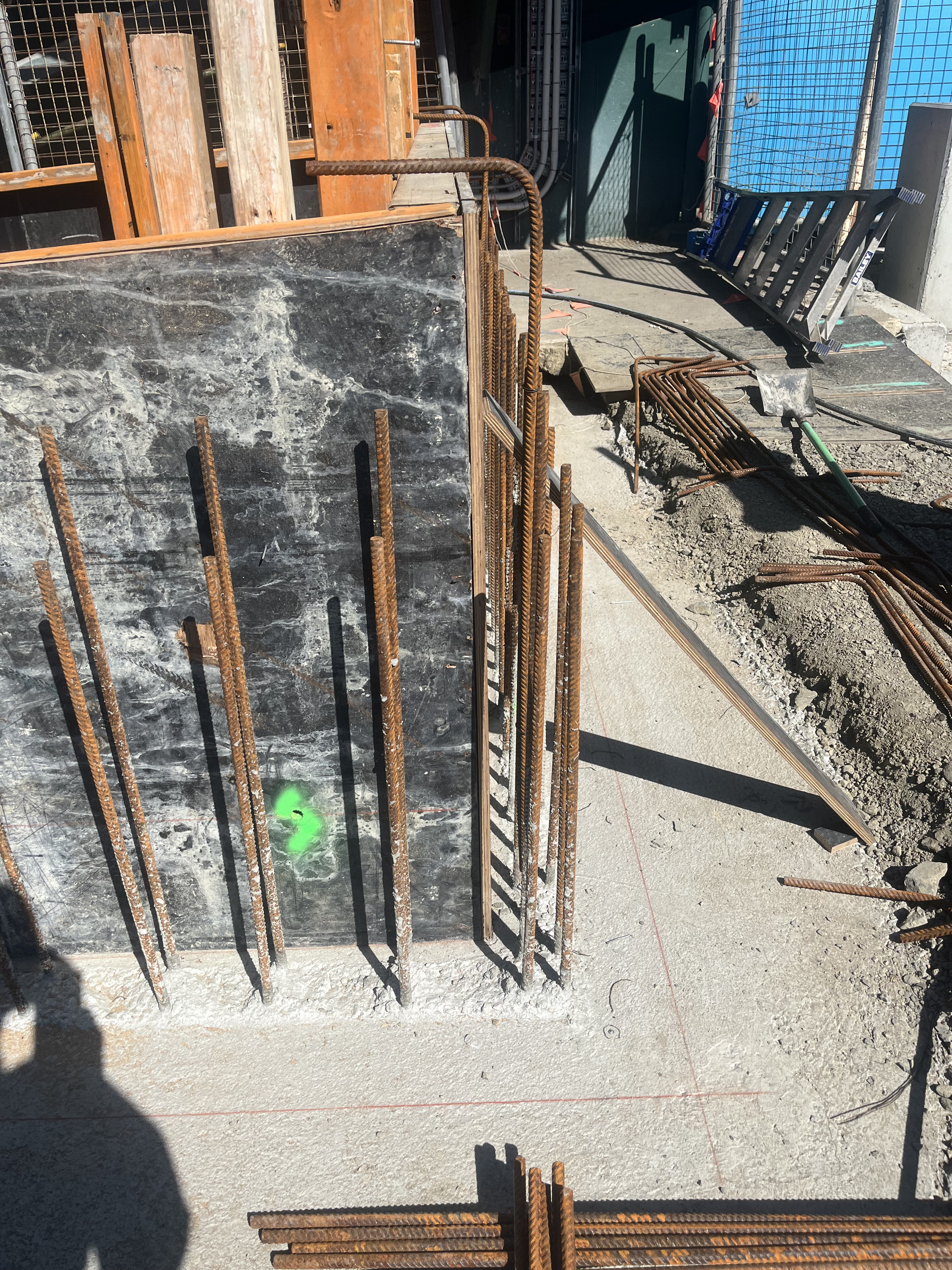 Vertical wall starter bars set into existing concrete slab at construction joint
